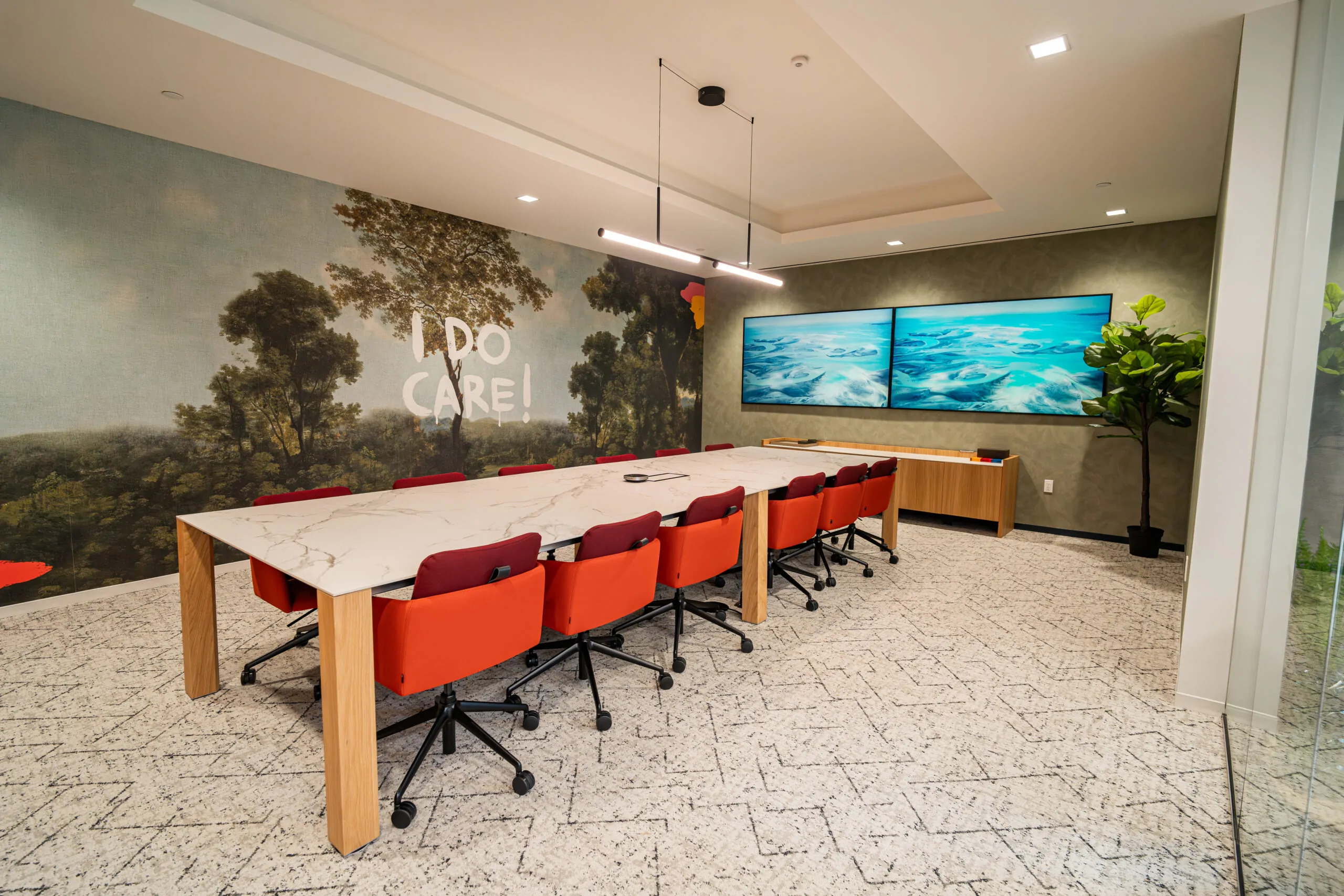 One Del Mar executive conference room with branded wall and modern seating